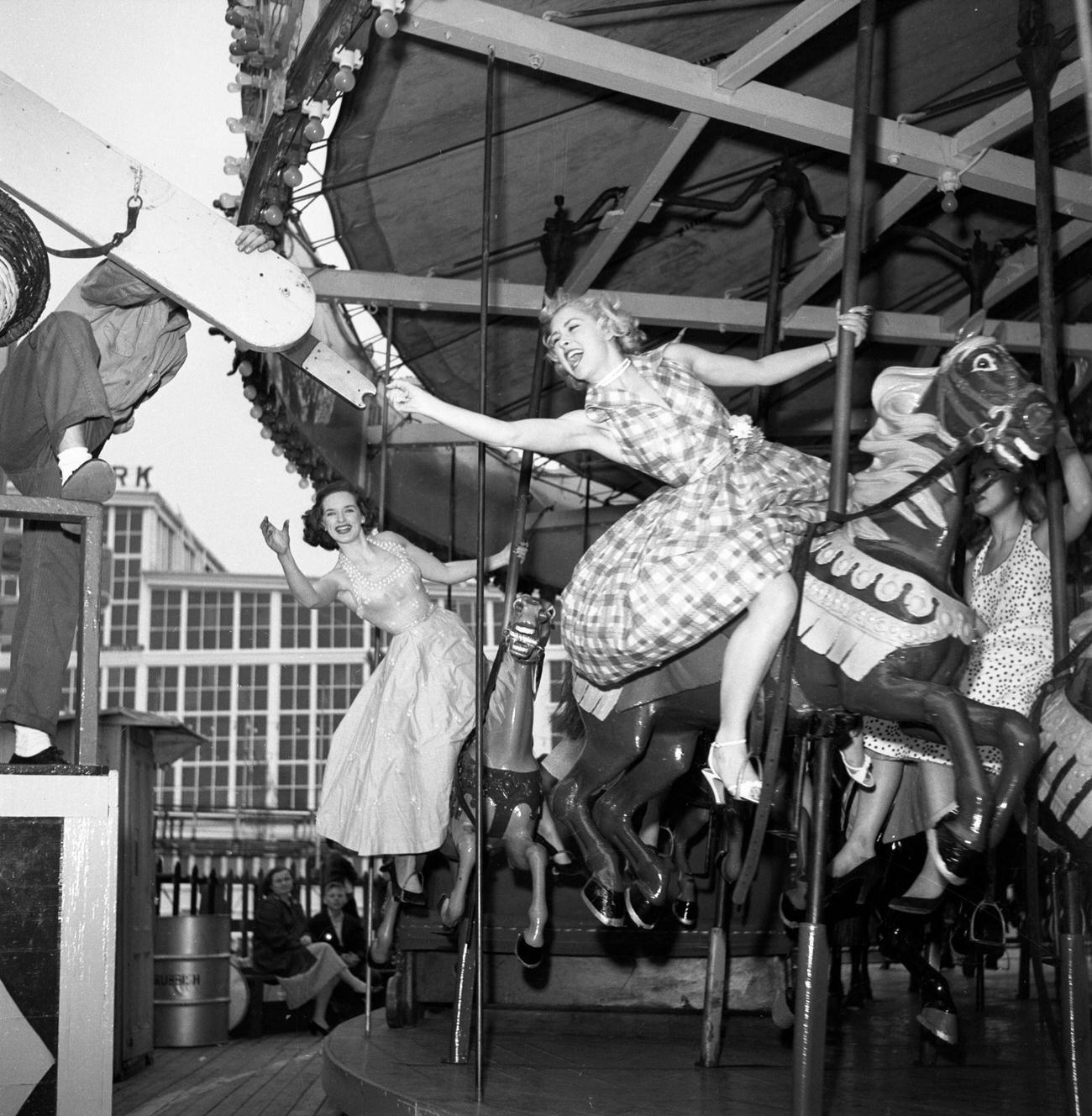 Cbs Model Cindy Robbins Grabs The Brass Ring On The Carousel, Pat Conway Behind Her, 1953.