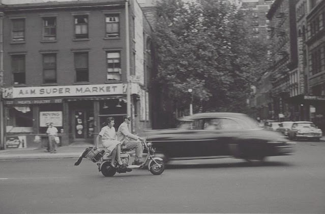 View Of Man And Woman On Motorized Scooter, A&Amp;Amp;M Super Market In Back, September 1957