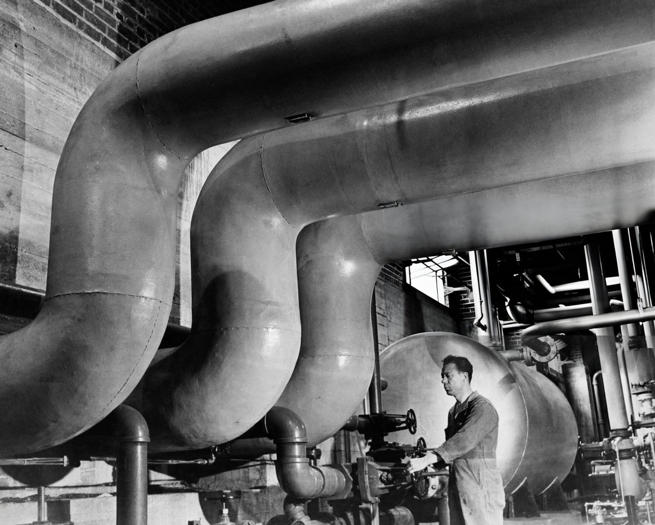 A Heating Engineer Inspects Pipes Carrying Steam To The Parkchester Housing Development In The Bronx, 1955.