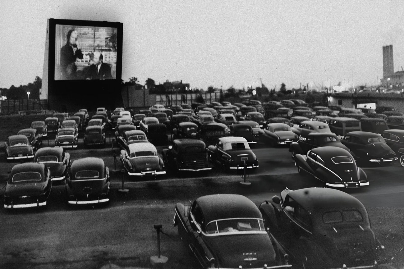 At The Whitestone Bridge Drive-In Movie Theater In The Bronx, New York, People Watch A Movie From Their Cars, 1951.