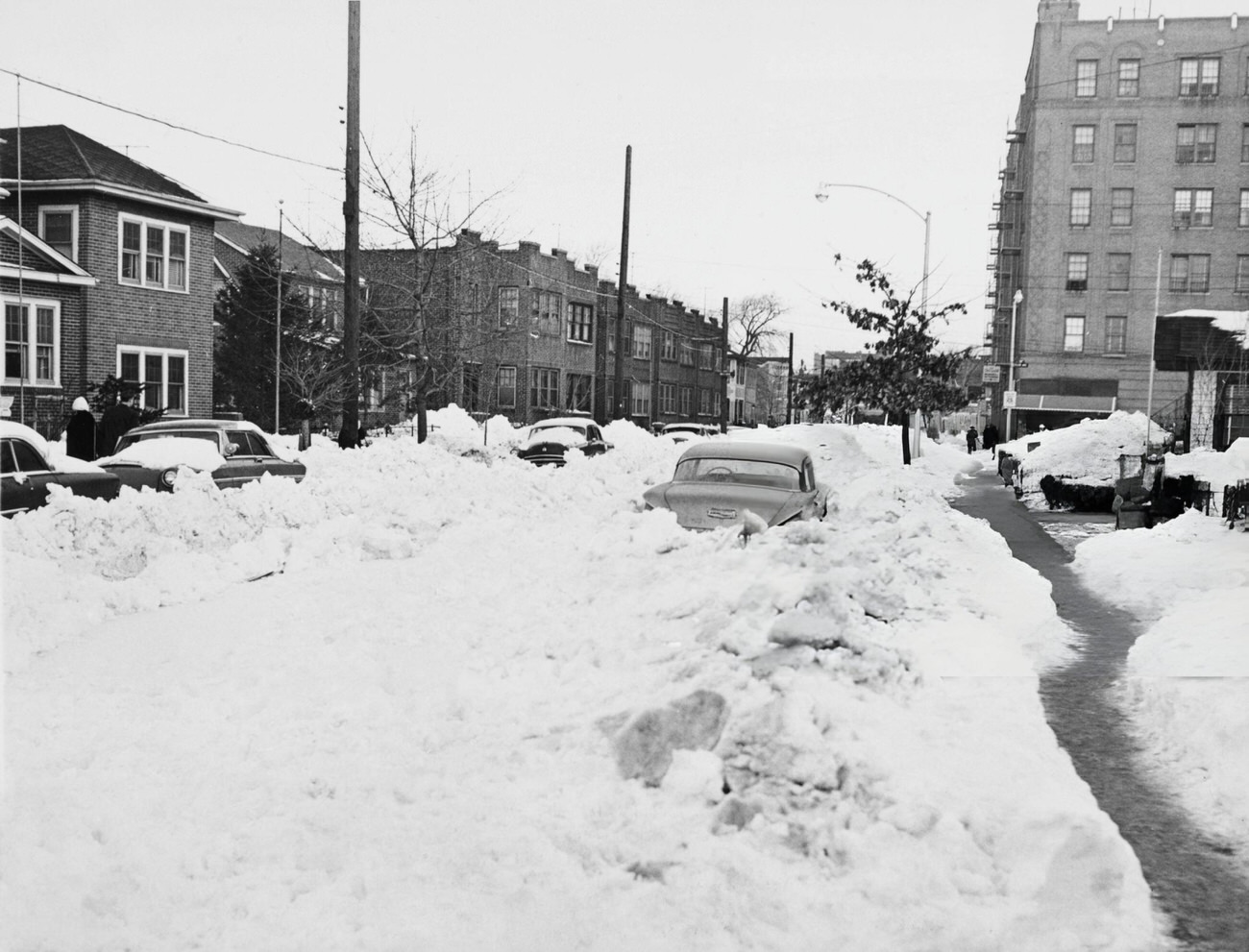 Mounds Of Snow Partly Bury Cars On An Unplowed Street In The Bronx, New York City, During A Blizzard In 1961