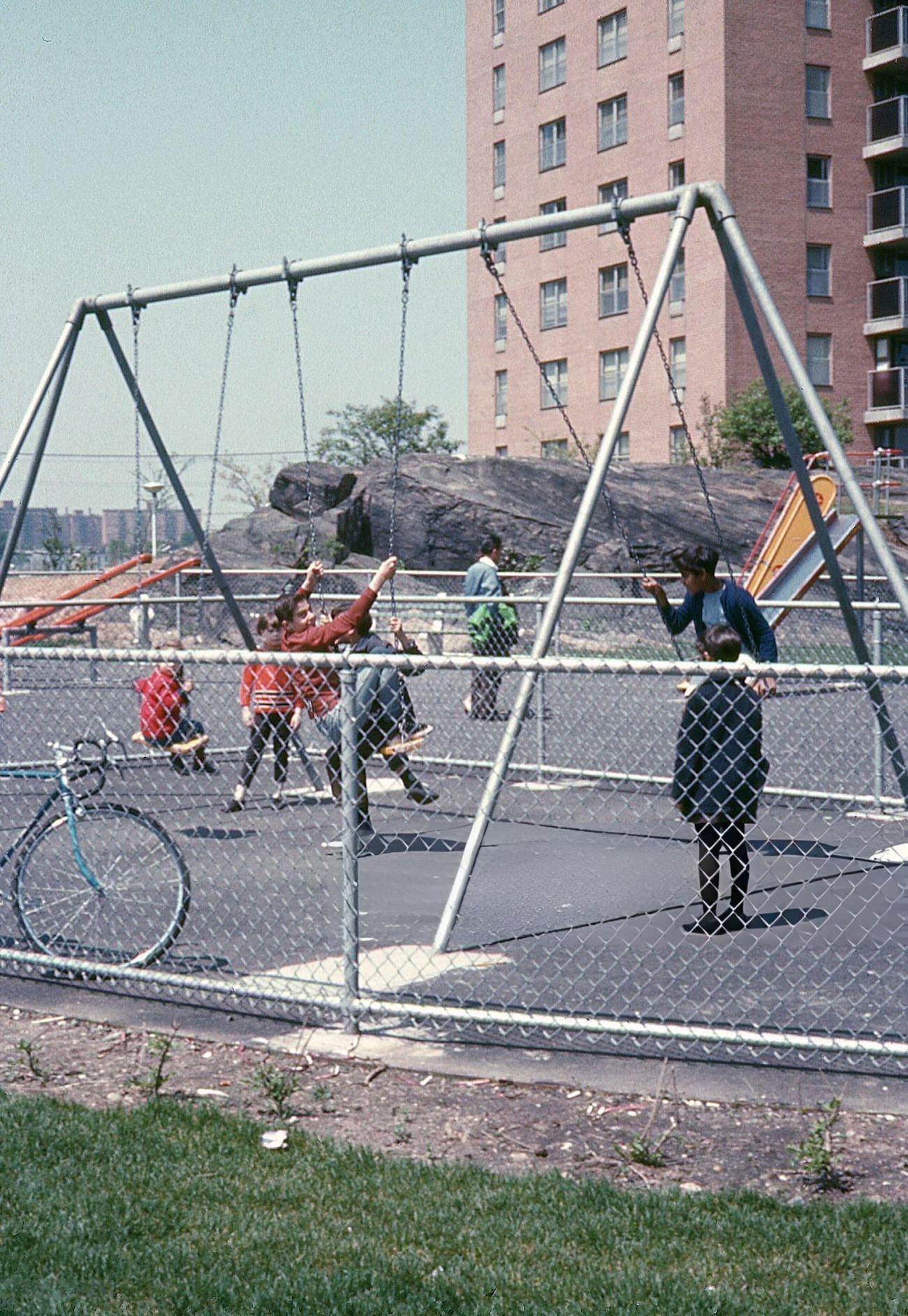 Caucasian And African American Children Play On A Swing Set At A Housing Project In The Bronx, 1968.