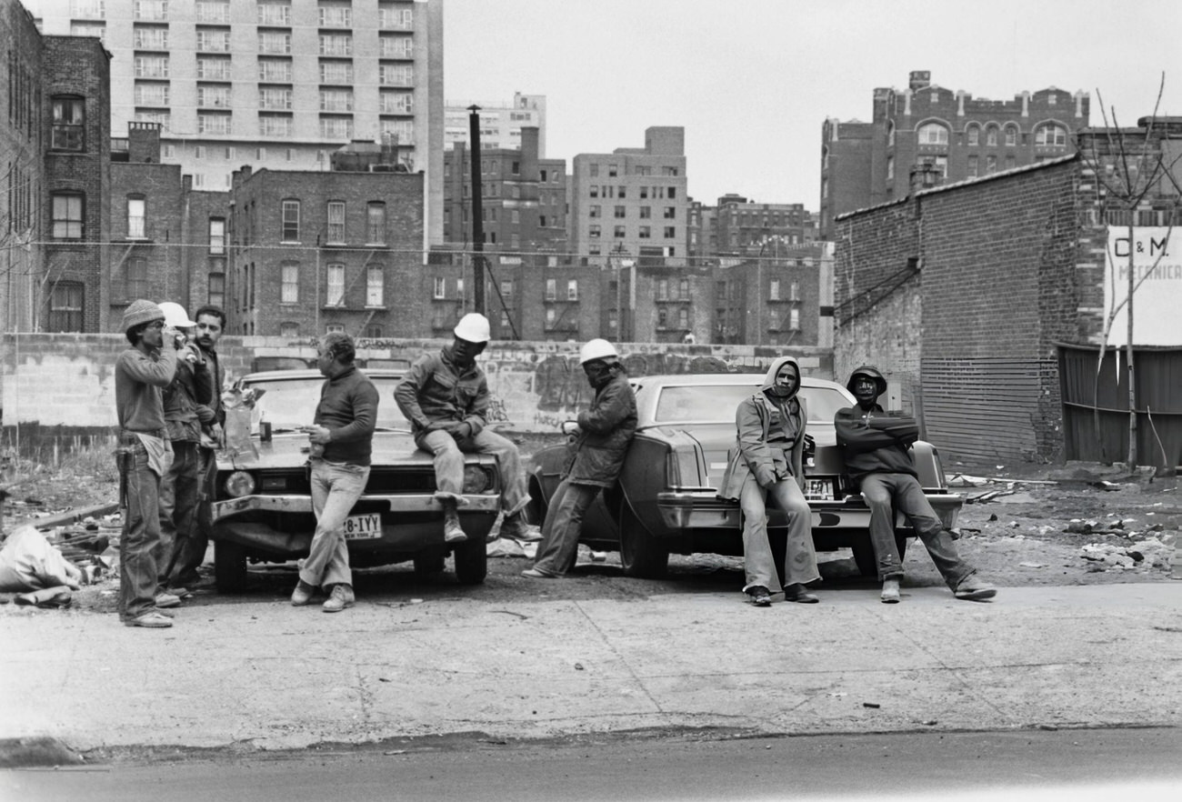 Construction Workers Take A Lunch Break Against Cars In The Bronx, Circa 1975.