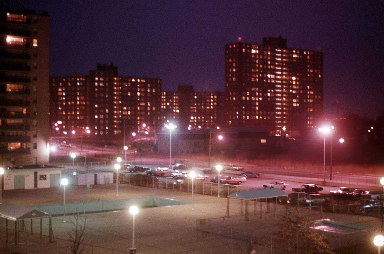 Streetlights Illuminate A Parking Lot And Sports Fields Near A Bronx Housing Project, 1974.