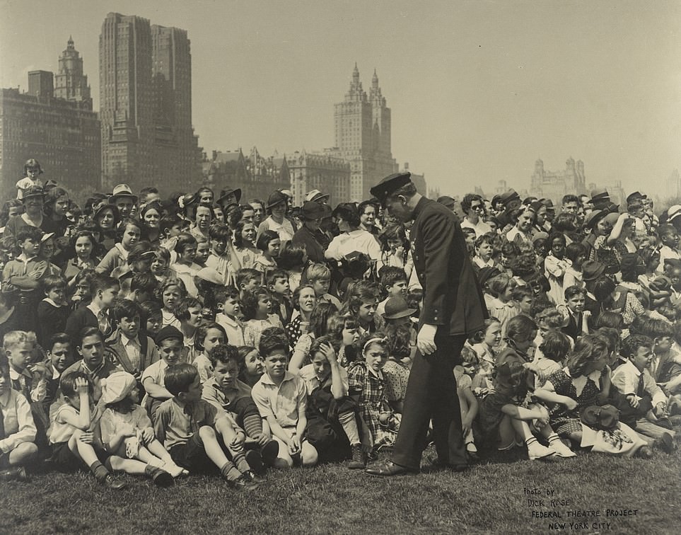 A Police Officer In Front Of A Crowd Of Children And Adults At A Works Progress Administration Theater Performance In Central Park, New York City, 1930S.