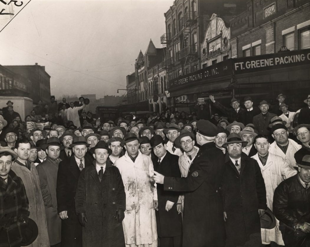 Weegee (Arthur Fellig): Retail Butchers Lined Up At Ft. Greene Market, Brooklyn, March 19, 1943.
