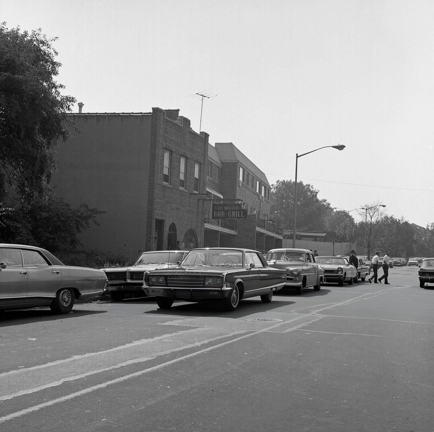 Vehicles Double Parked In Front Of John Malossi Bar &Amp;Amp; Grill At 111-12 37Th Avenue In Corona, 1967.