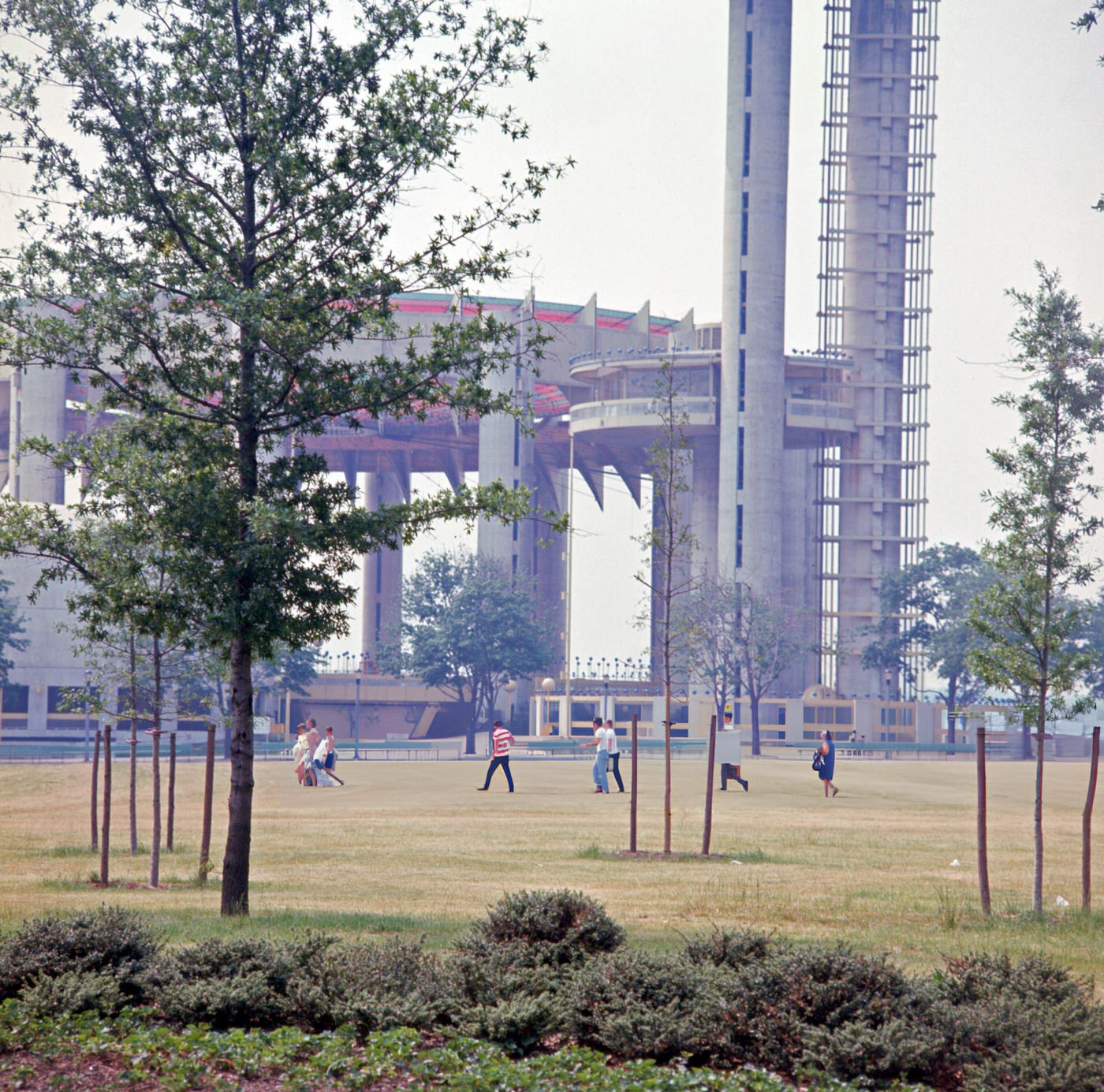 People On A Lawn Next To The World'S Fair Pavilion And Observation Towers, Flushing Meadows Corona Park, 1967.