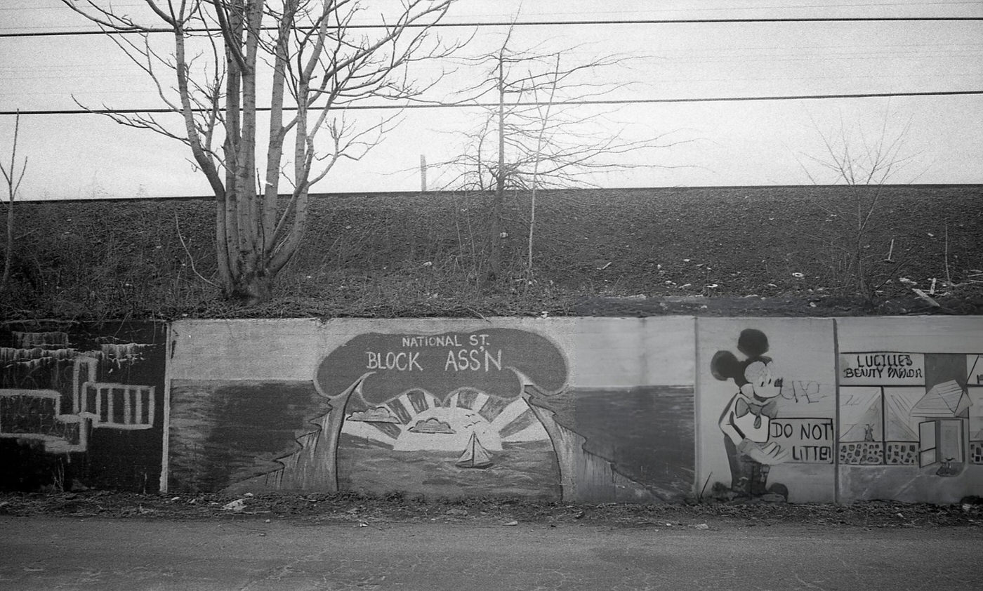 Graffiti On A Retaining Wall Features An Ocean-Themed Mural With Mickey Mouse And Lucille'S Beauty Parlor, Corona, Queens, 1982.