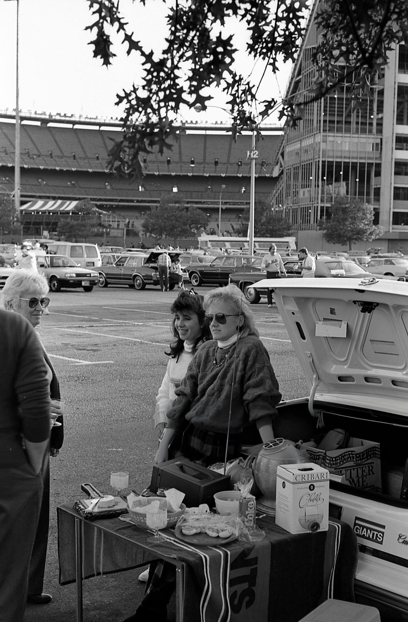 A Group Of Baseball Fans Tailgate In A Parking Lot Outside Shea Stadium Before Game Six Of The 1986 World Series, Corona, Queens, 1986.