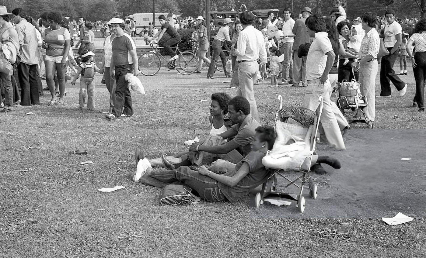 A family relaxes on the grass in Flushing Meadows Park, Corona, Queens, 1980.