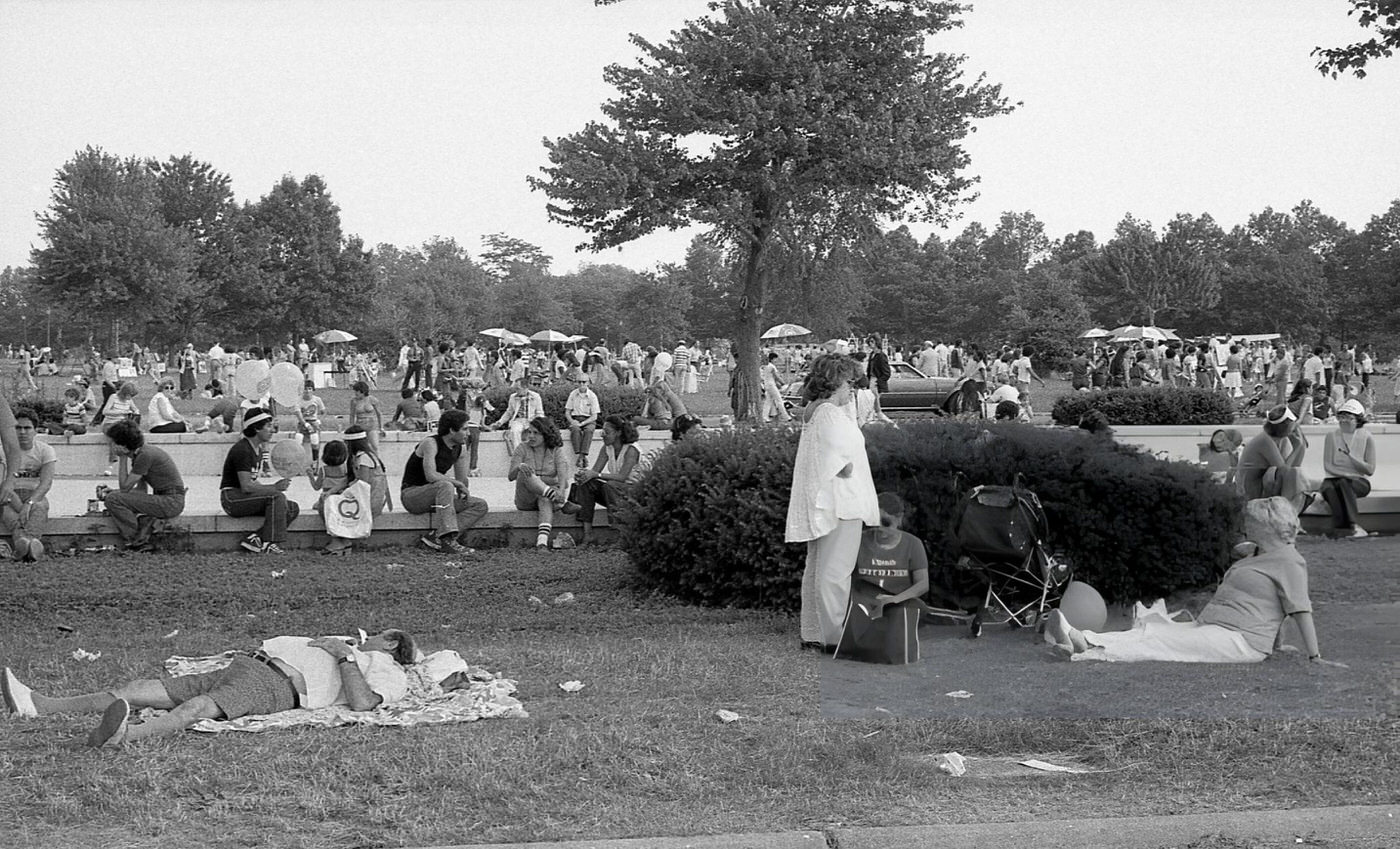 People relax on the lawn in Flushing Meadows Park, Corona, Queens, 1980.