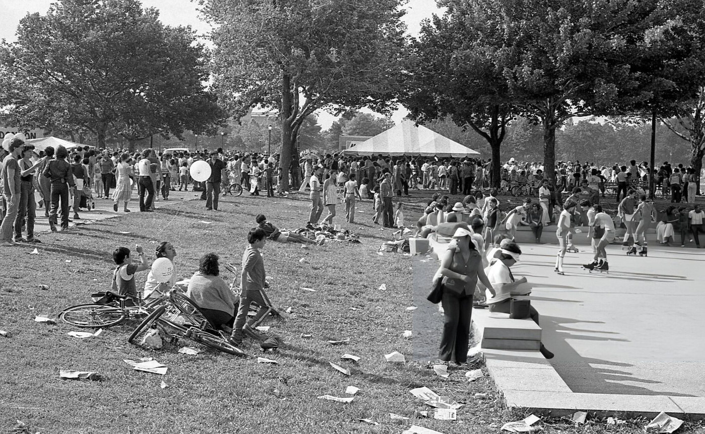 People gather on the lawn, footpaths, and recreational areas in Flushing Meadows Park, Corona, Queens, 1980.