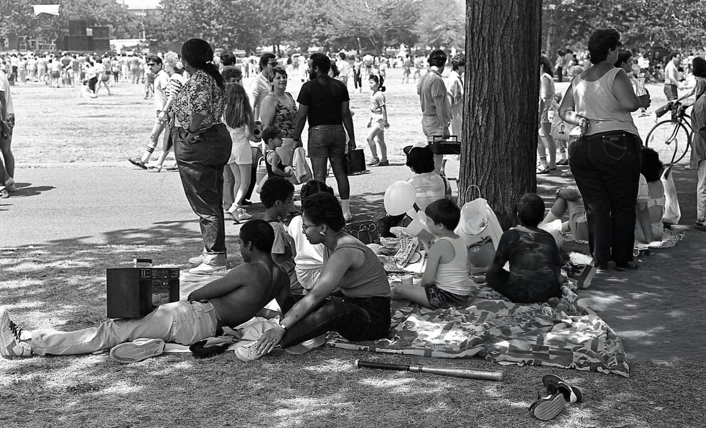 A family relaxes on the grass in Flushing Meadows Park in Corona, Queens, 1986.