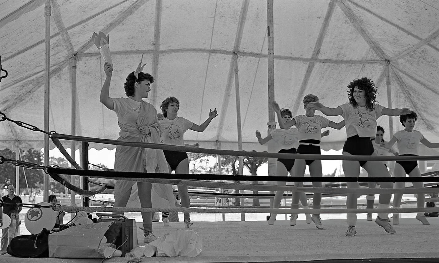 Aerobics instructors work their routine in a boxing ring in Flushing Meadows Park, Corona, Queens, 1986.