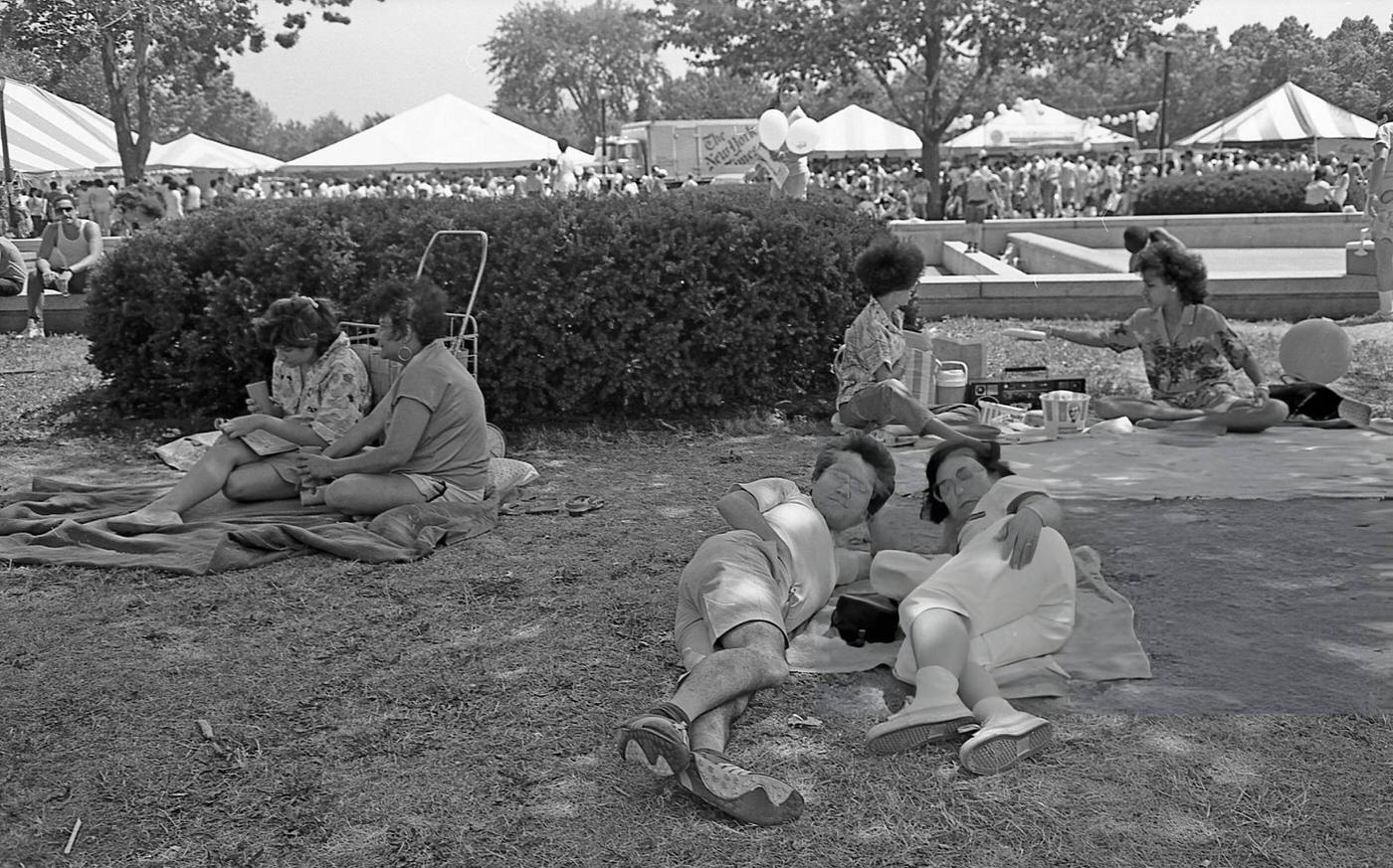 People lie on the grass in Flushing Meadows Park, Corona, Queens, 1986.