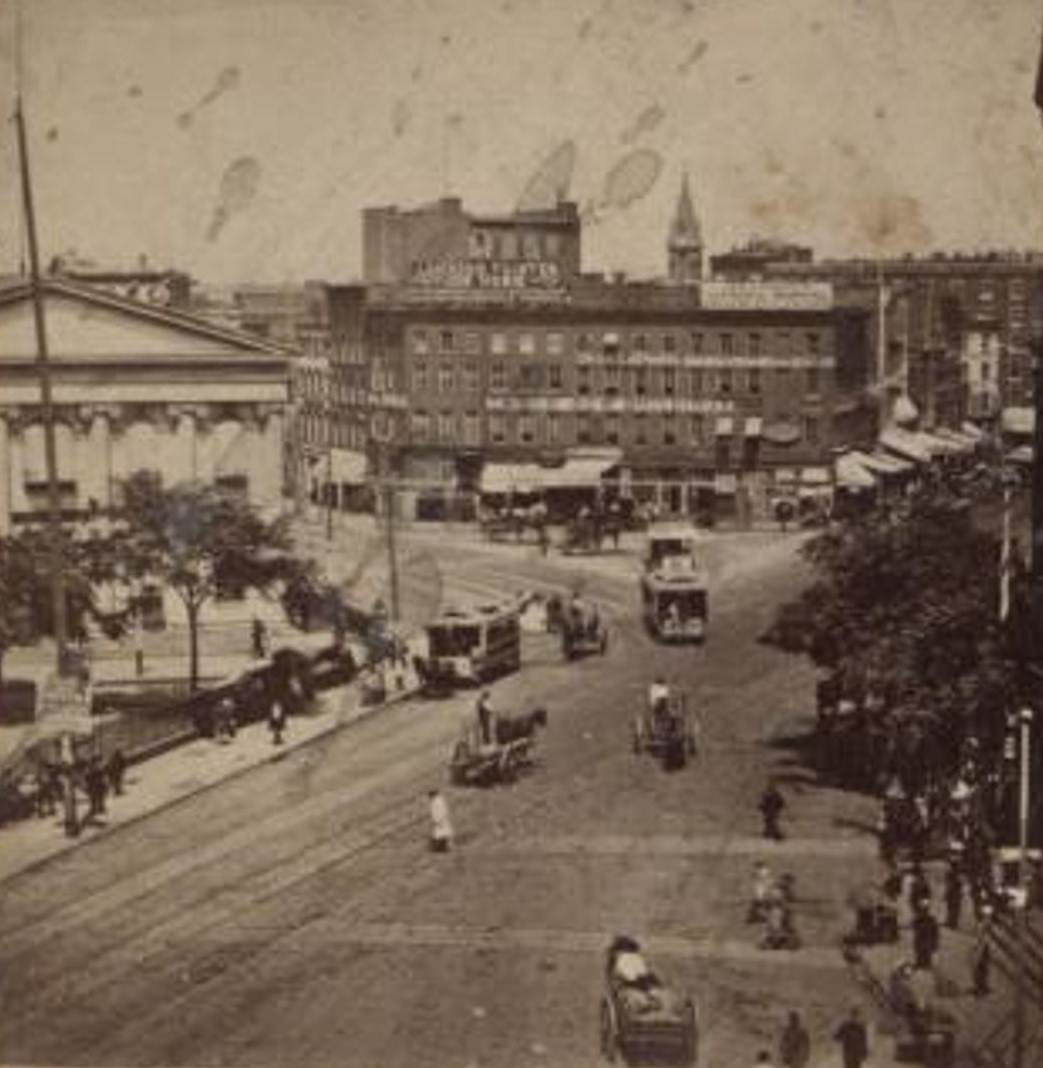 View Of Buildings, Horse Carriages And Trolley, 1865.