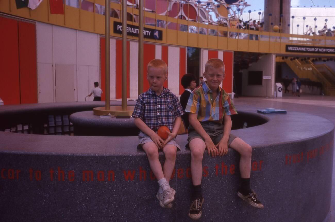 Two Young Boys Sit On The Edge Of A Circular Counter Inside The New York State Pavilion At The New York World'S Fair, Flushing Meadows Park, 1964.