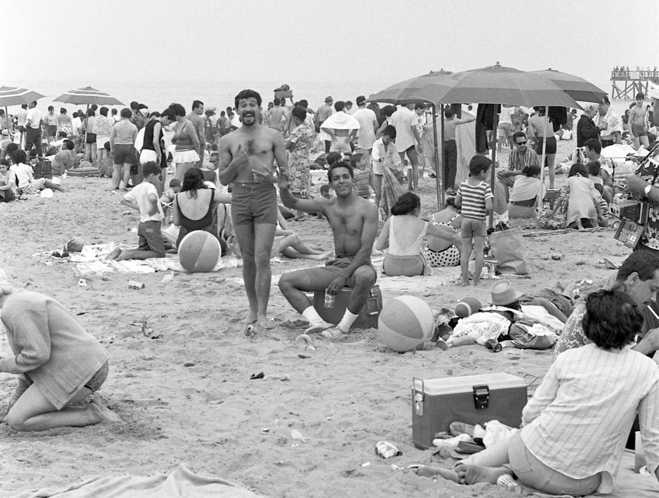 Men Posing For A Photo On A Crowded Coney Island Beach, Brooklyn, 1968.