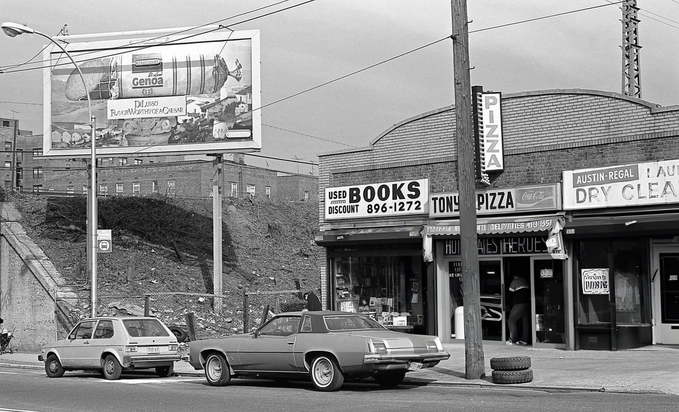 Businesses On 63Rd Drive In Rego Park, Queens, Including A Used Bookstore, Tony'S Pizza, And Austin-Regal Laundry And Dry Cleaners, 1984.
