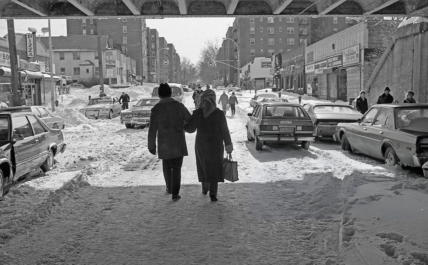 A Couple Walks Arm In Arm Under A Long Island Rail Road Trestle After A Blizzard, Rego Park, Queens, 1983.