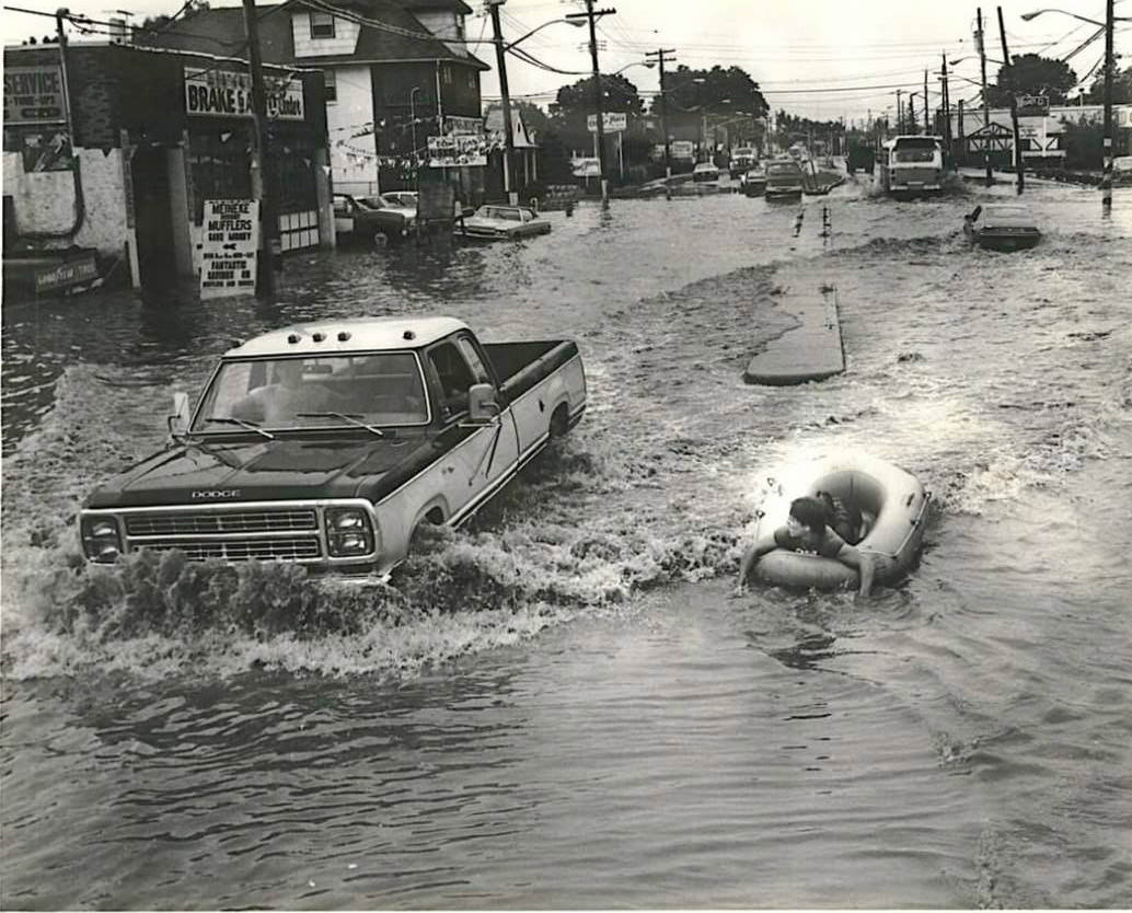 Joe Giunta Finds It Easier To Travel Down Hylan Boulevard In A Raft After Flooding, July 29, 1982.