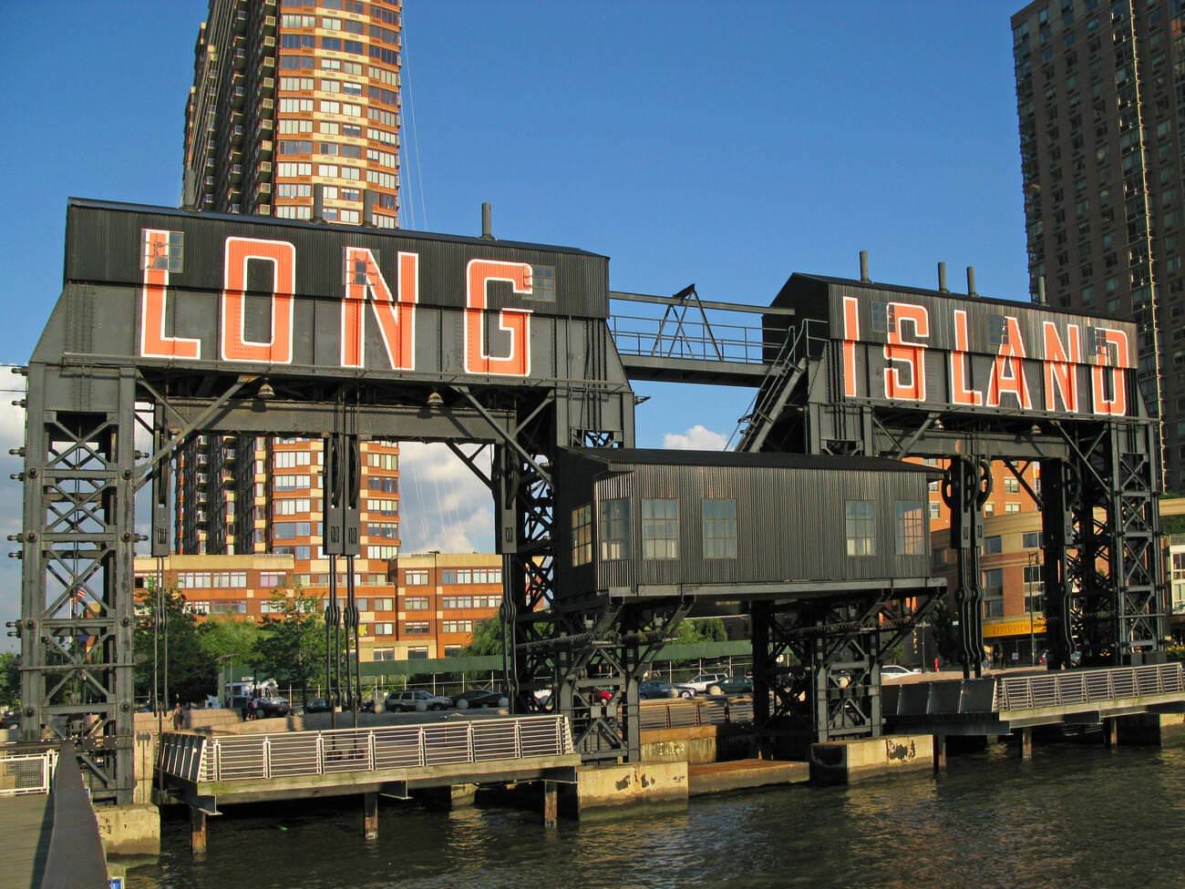 Long Island Sign And Old Rail Car Landing With New Buildings On The Waterfront, Queens, 2008.