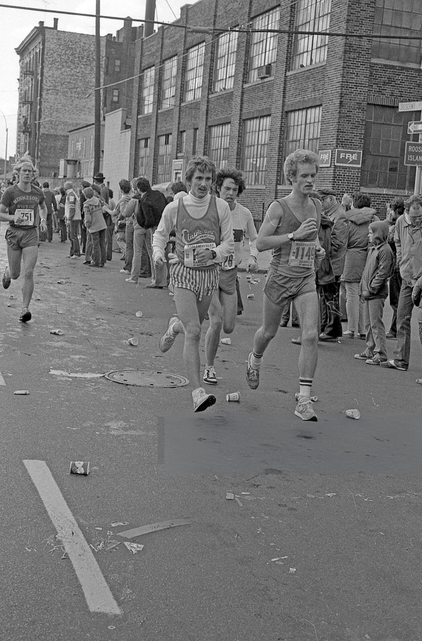 Runners pass the 14-mile marker on Crescent Street during the New York City Marathon, Queens, 1980.