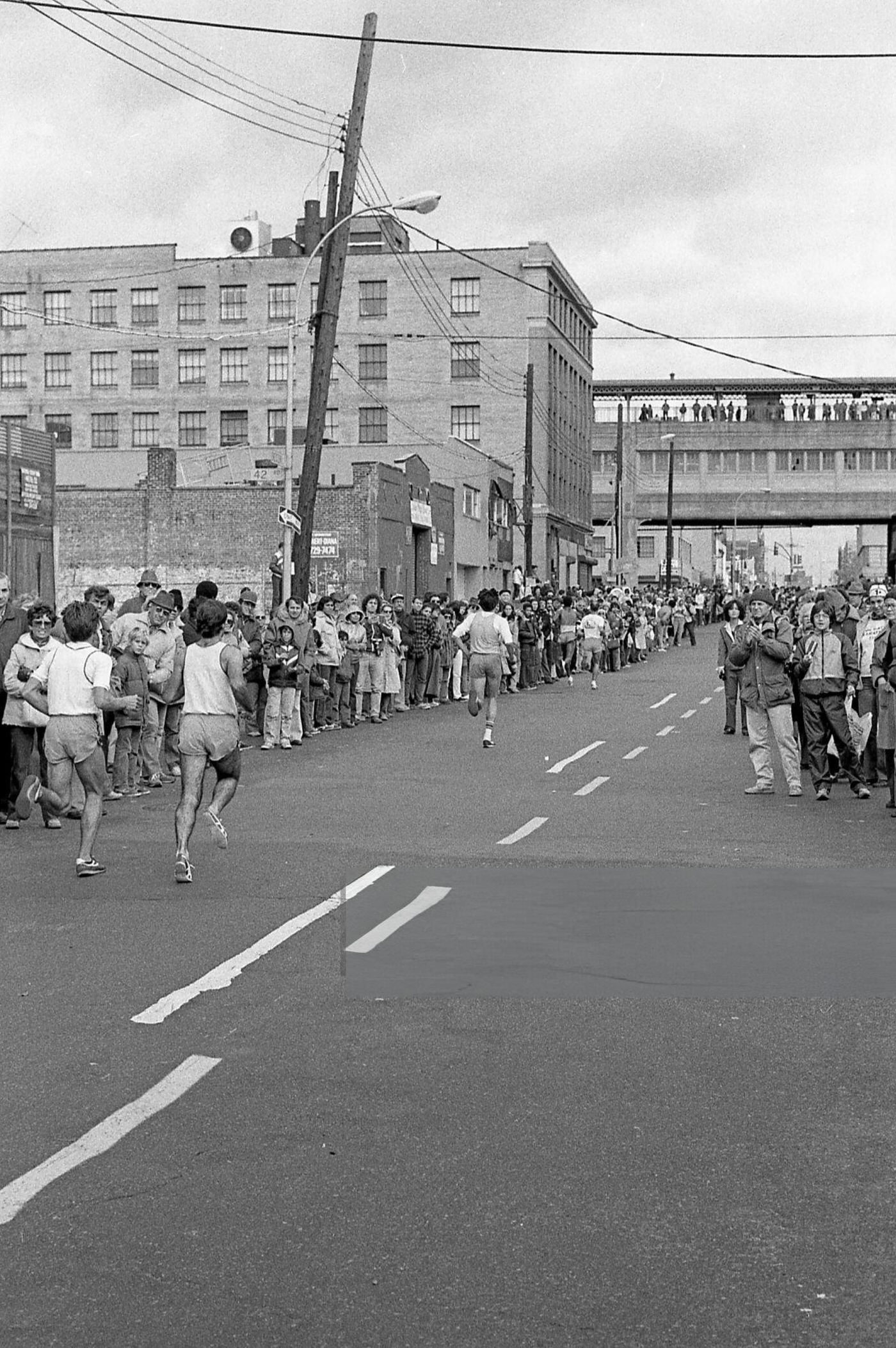 Spectators Line Crescent Street As Runners Approach Queens Boulevard During The New York City Marathon, Queens, 1980.