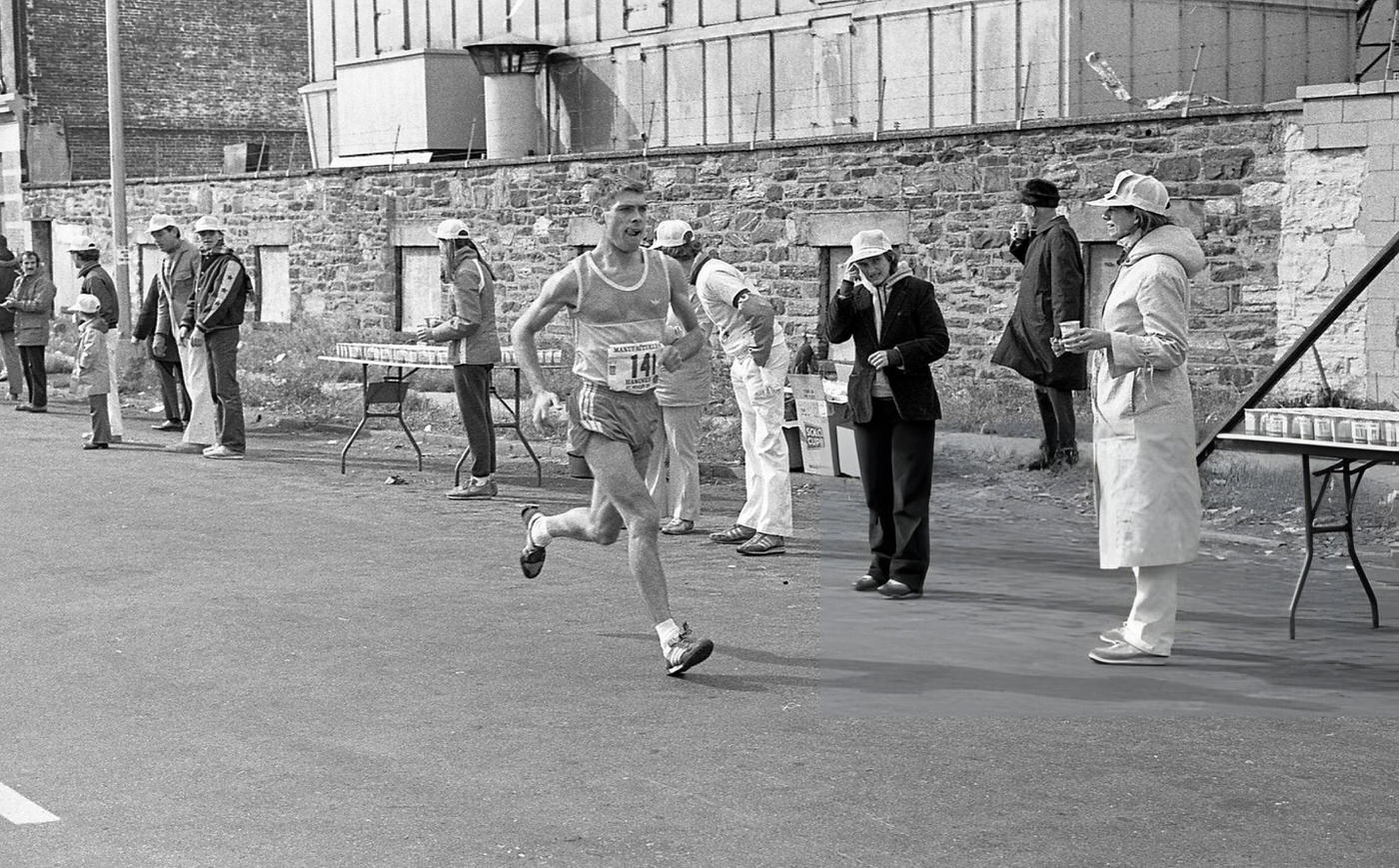 A runner passes the 14-mile marker on Crescent Street during the New York City Marathon, Queens, 1980.