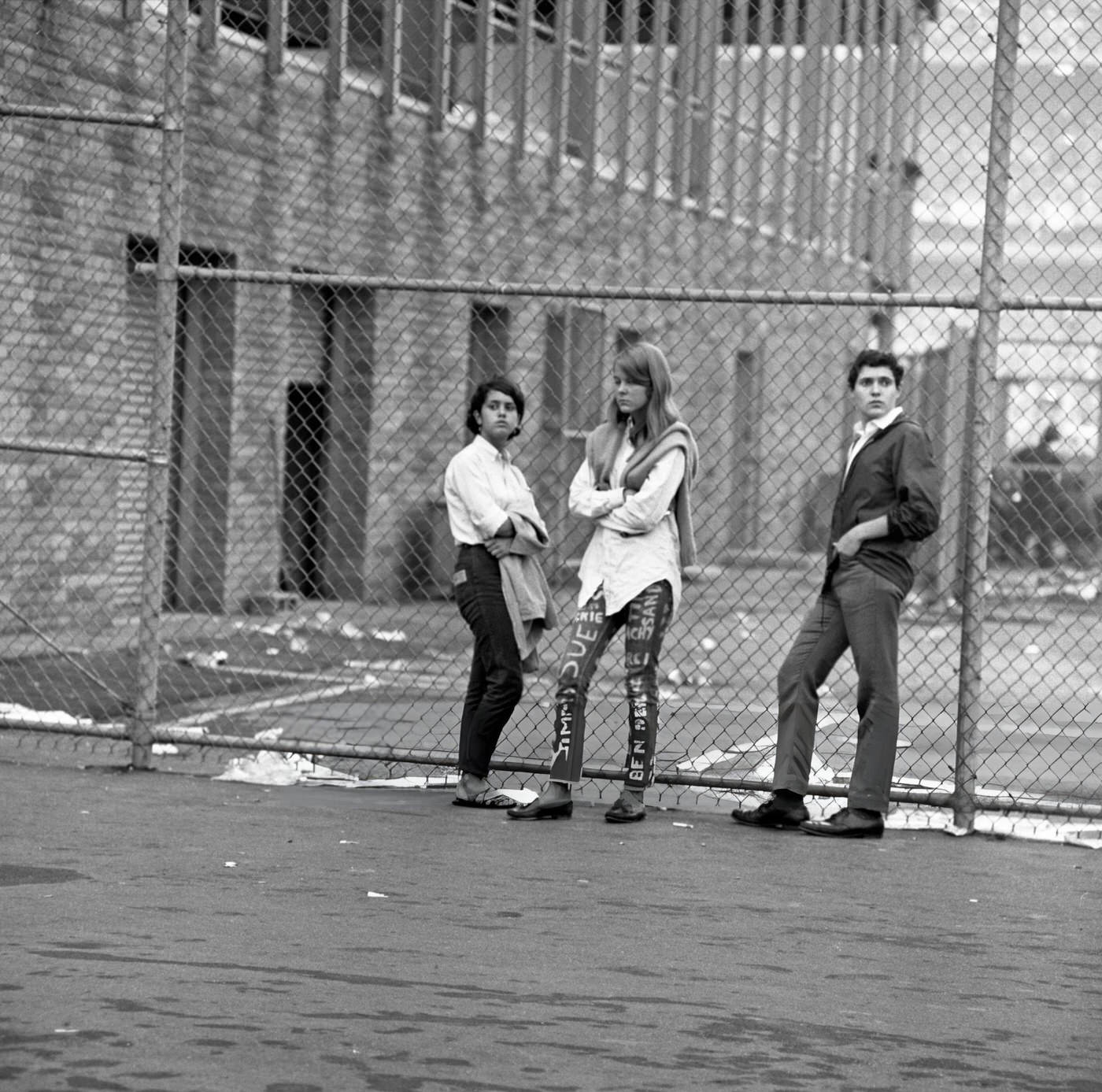 Three Somber-Looking Fans Unable To Attend The Beatles Concert Stand By A Fence Around The Back Of Shea Stadium, 1966.
