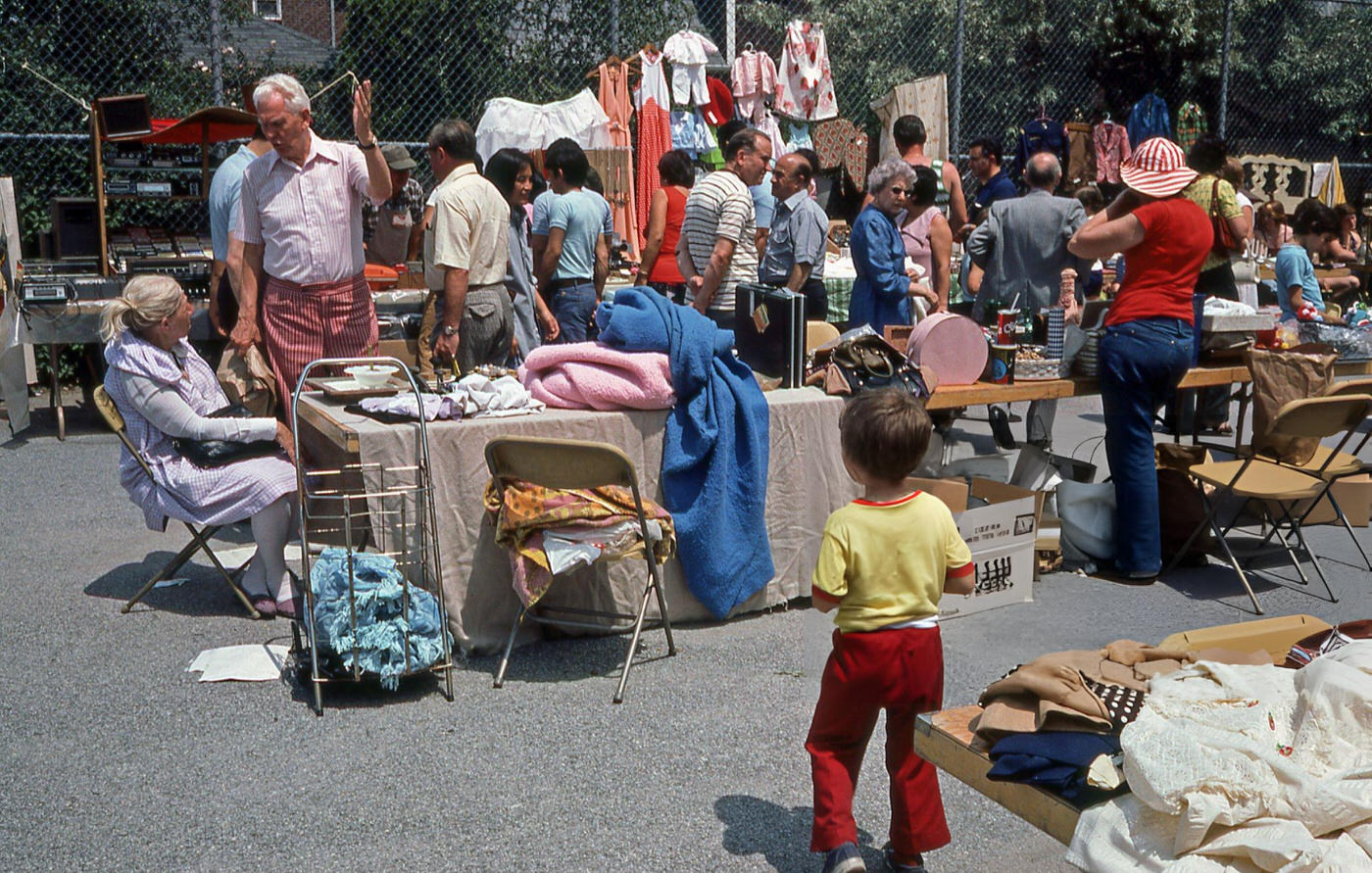 A Child Approaching A Vendor'S Table At An Outdoor Flea Market On Woodhaven Boulevard In Rego Park, Queens, 1970S.