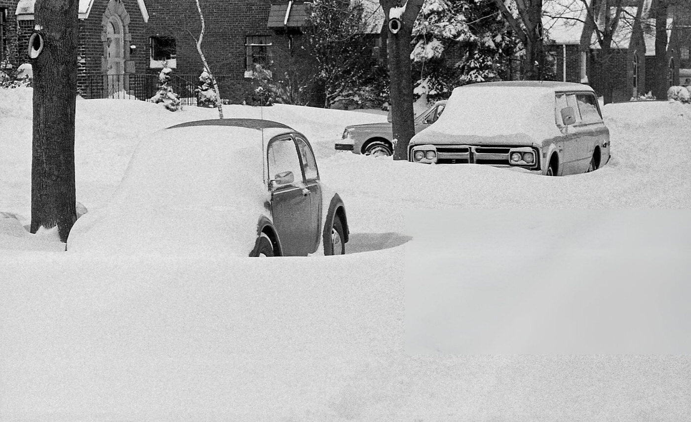 Two Vehicles Sit Buried On A Residential Street Under Deep Snow Drifts In The Aftermath Of The Blizzard Of 1978.