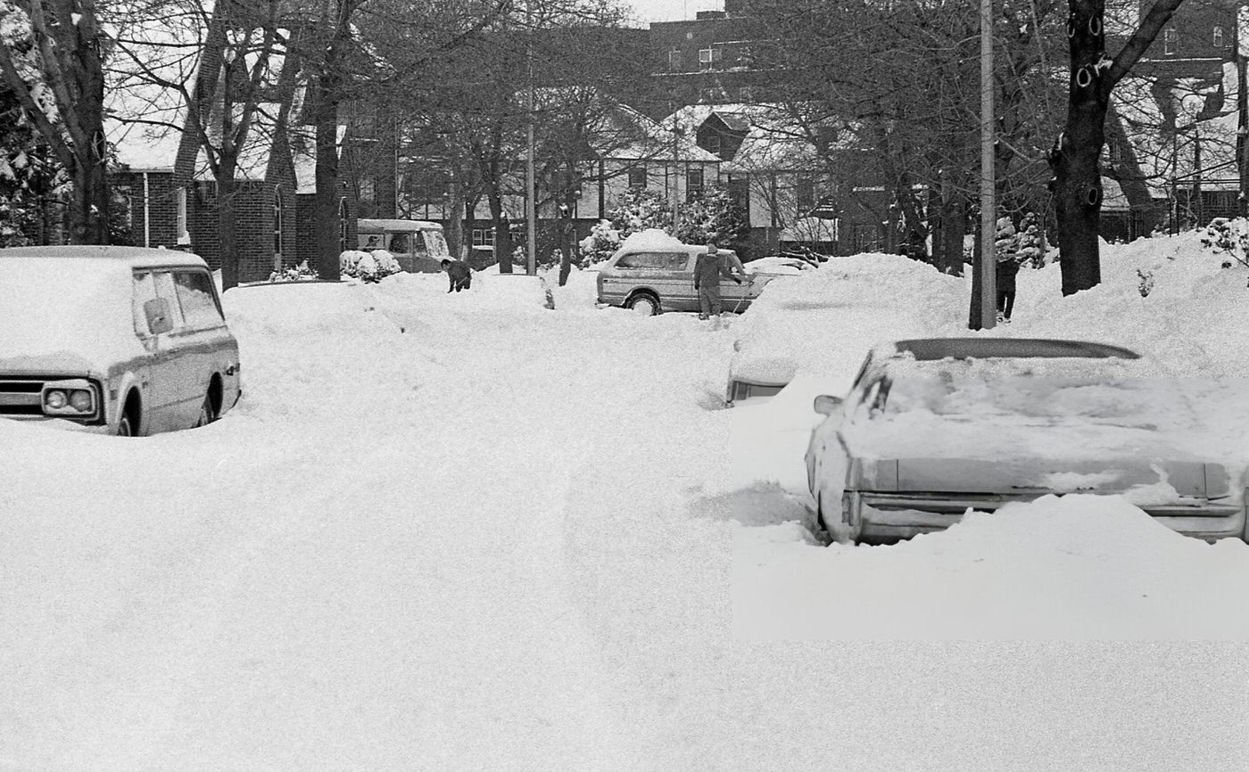 A Man Digs His Stuck Vehicle Out Of Deep Snow On A Residential Street In Queens In The Aftermath Of The Blizzard Of 1978.
