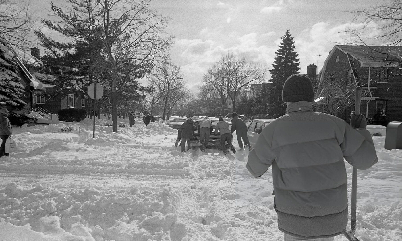 A Group Of Men Help Push A Stranded Vehicle Through A Residential Intersection In Queens In The Aftermath Of The Blizzard Of 1978.