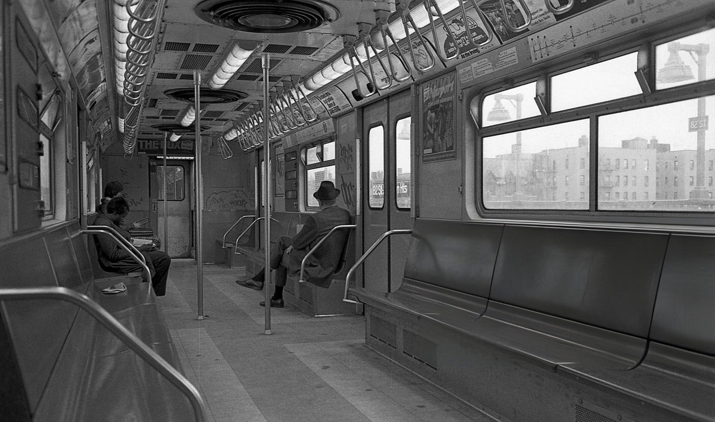 Three Commuters Sit In A Graffiti-Covered Subway Car As It Travels Through Corona, Queens, 1974.