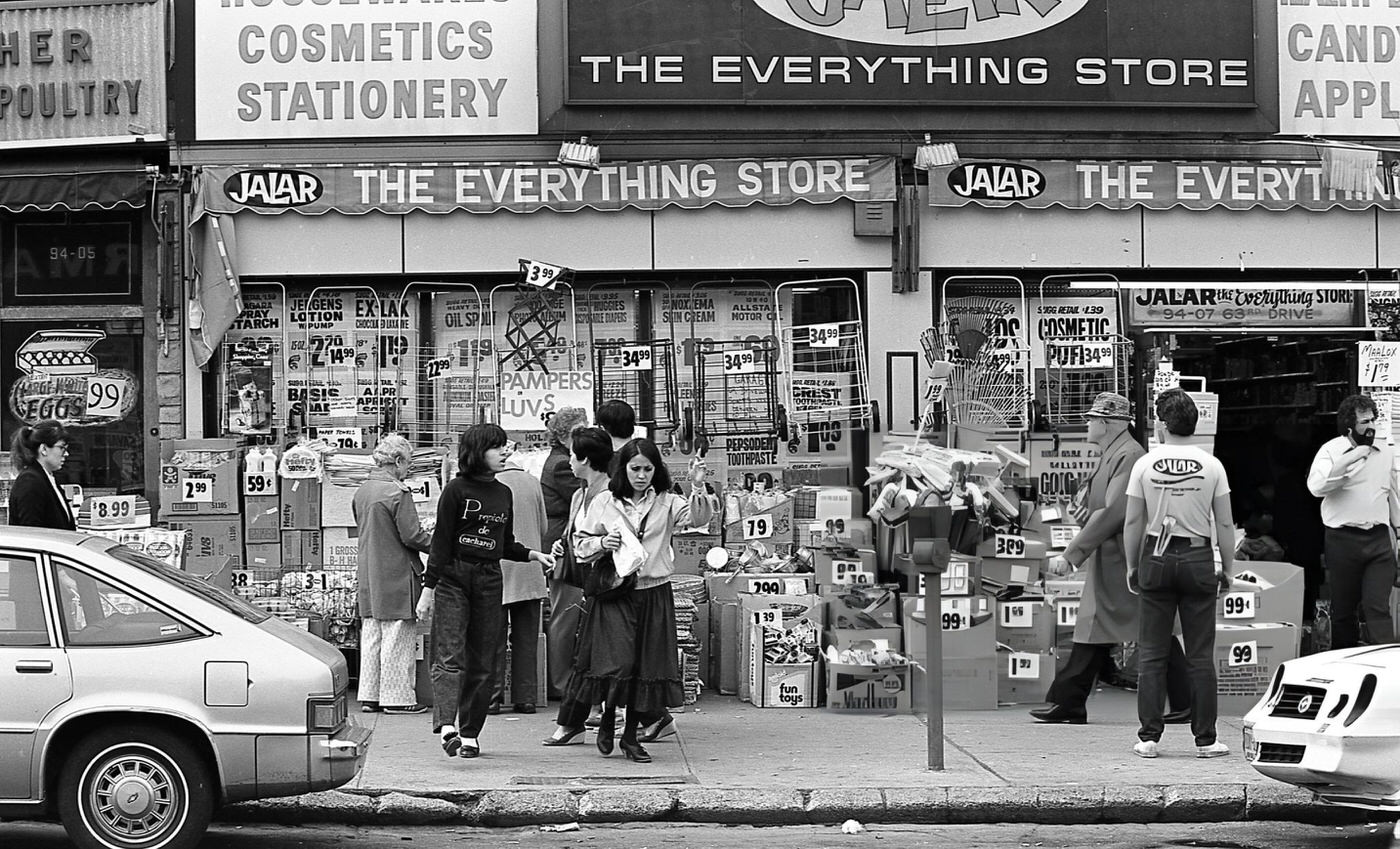 Pedestrians And Shoppers In Front Of Jalar, 'The Everything Store', In Rego Park, Queens, 1984.