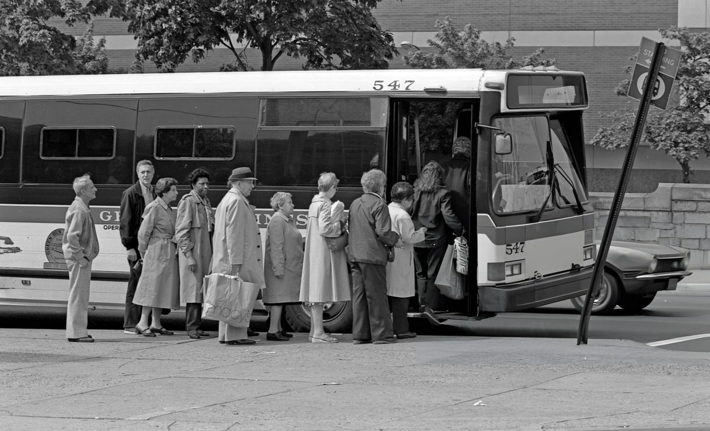 Commuters Board The Green Bus Lines' Q60 Bus On Queens Boulevard In Elmhurst, Queens, 1984.
