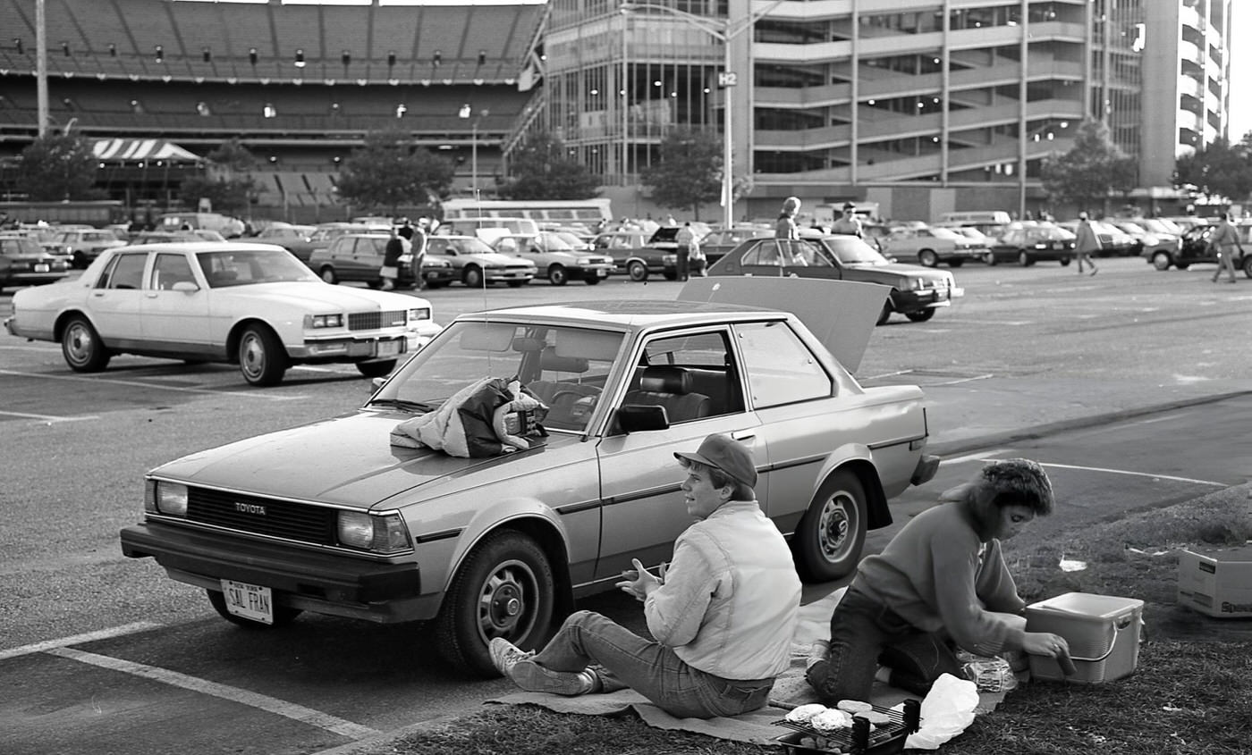 Two Baseball Fans Tailgate In A Parking Lot Outside Shea Stadium Before Game Six Of The 1986 World Series, Corona, Queens, 1986.