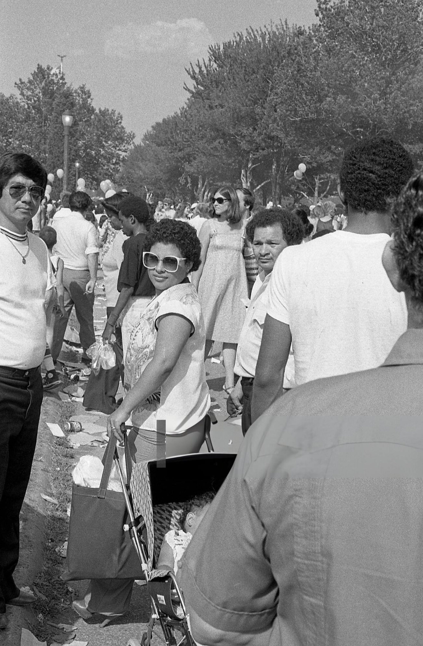 People Crowd On A Footpath In Flushing Meadows Park, Corona, Queens, 1980.