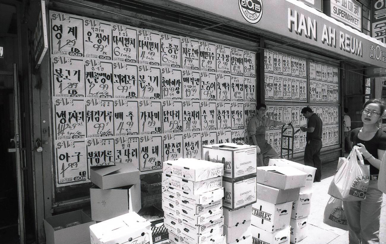 The Original Han Ah Reum Asian Supermarket In Woodside, Queens, New York City, Showing Sale Stickers And Food Cartons Outside, 1982.