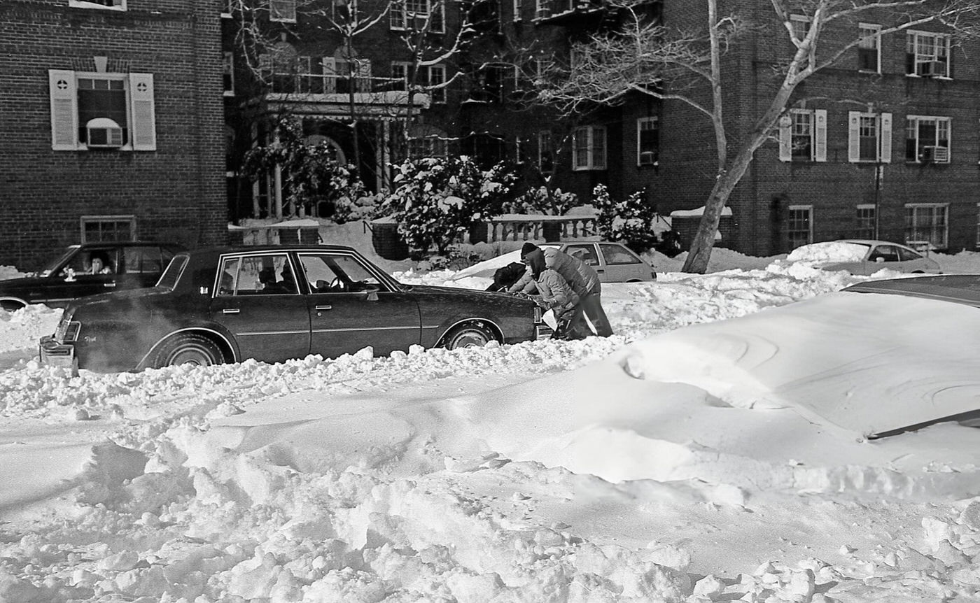 People Attempt To Free A Vehicle From Deep Snow On 63Rd Drive In The Aftermath Of A Blizzard In Rego Park, Queens, 1983.
