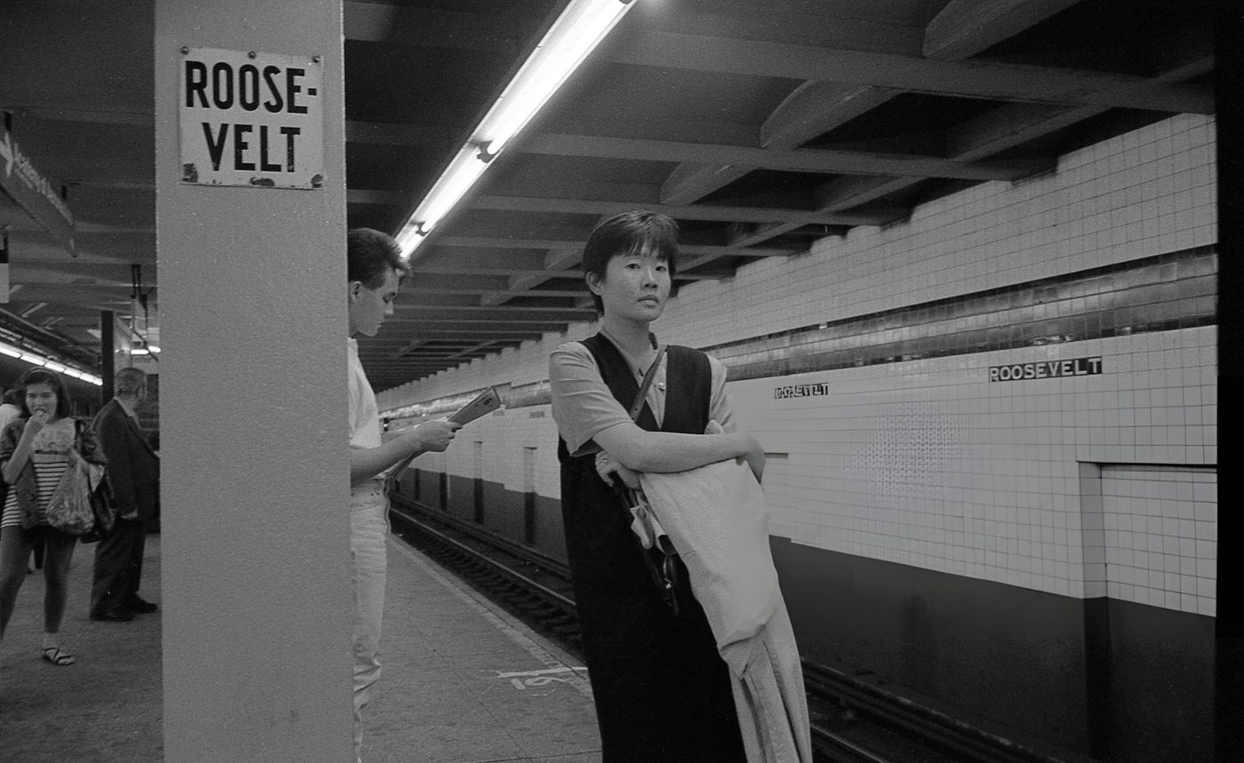 A Woman Stands On The Subway Platform At The Roosevelt Avenue Station In Jackson Heights, Queens, 1993.
