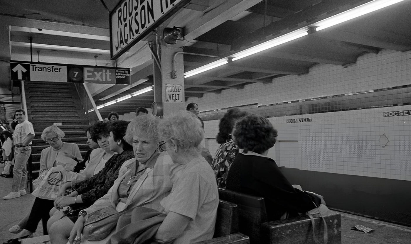 Commuters Sit On A Bench On The Subway Platform At Roosevelt Avenue In Jackson Heights, Queens, 1993.