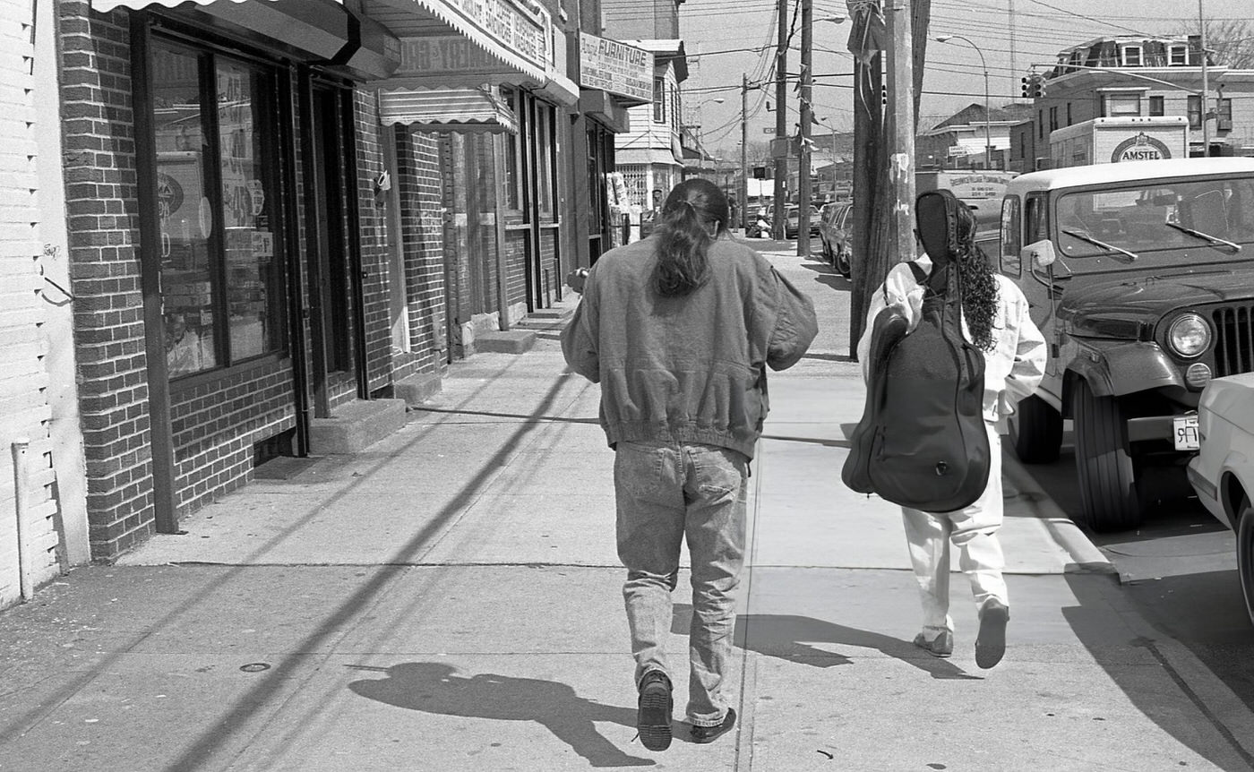 Two Men Walk Down National Street Near 43Rd Avenue In Corona, Queens, 1990.