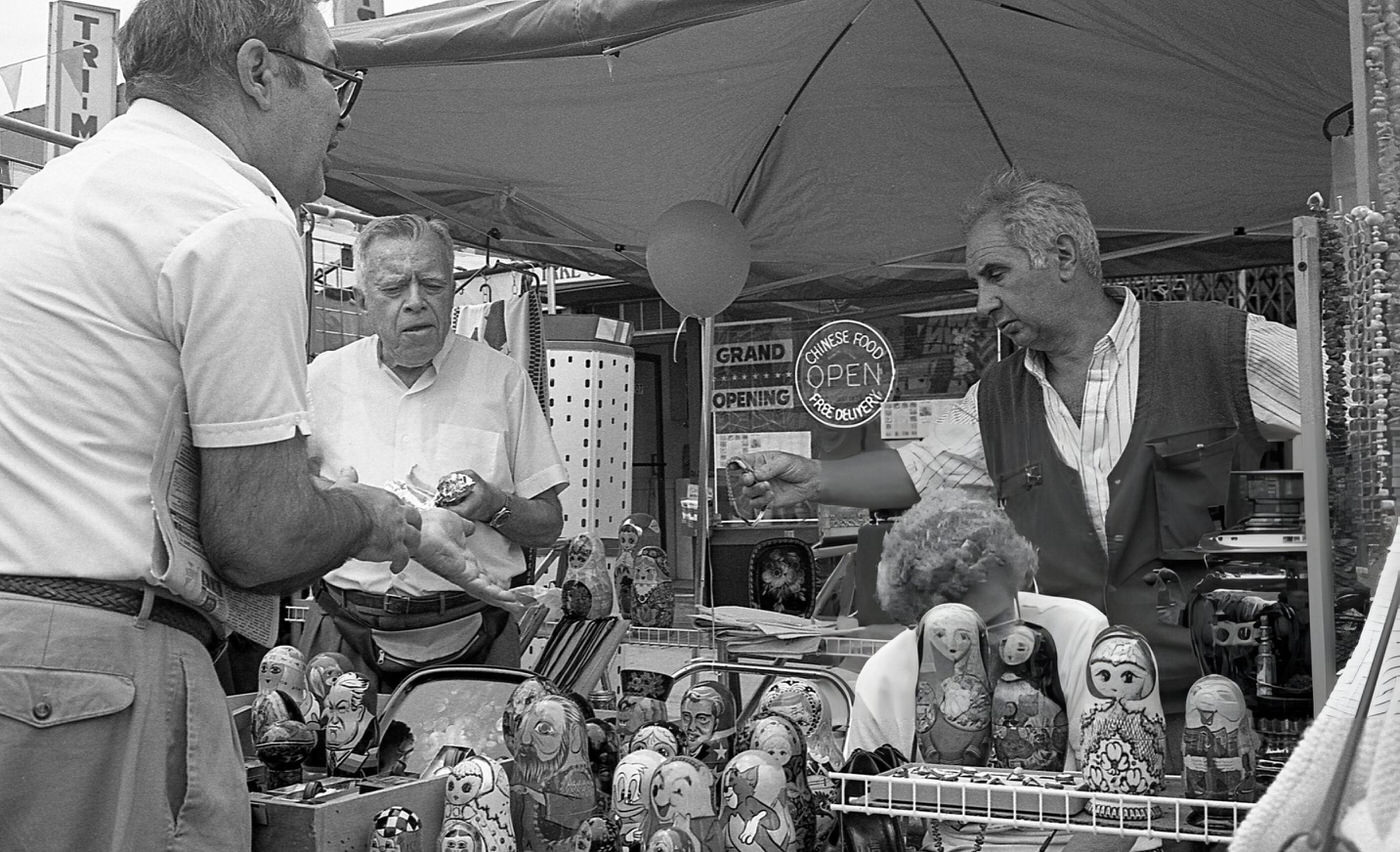Two Vendors, One Examining A Customer'S Watch, On 63Rd Drive During The 63Rd Drive Street Fair In The Rego Park Neighborhood, Queens, 1995.