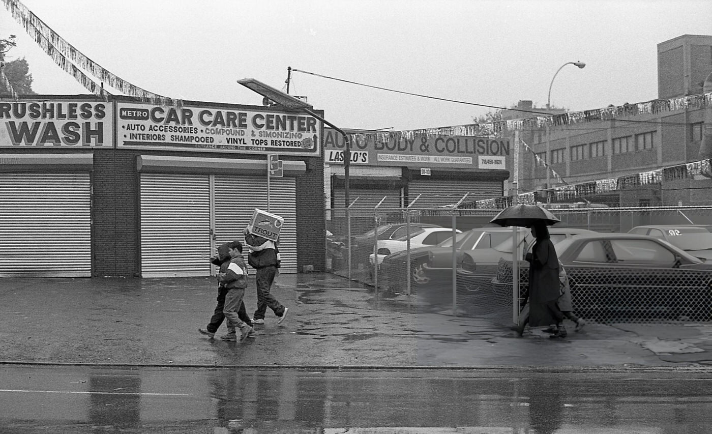 Pedestrians Walking Past An Auto Repair Shop On Metropolitan Avenue In Queens' Forest Hills Neighborhood, 1997.