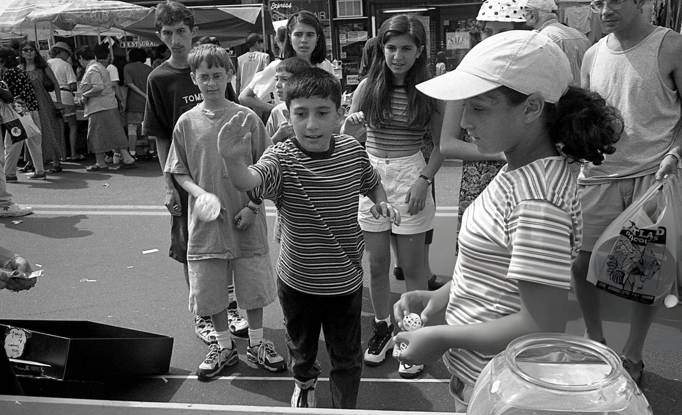 A Boy Throws A Ball At A Gaming Booth On 63Rd Drive During The 63Rd Drive Street Fair, Rego Park, Queens, 1997.