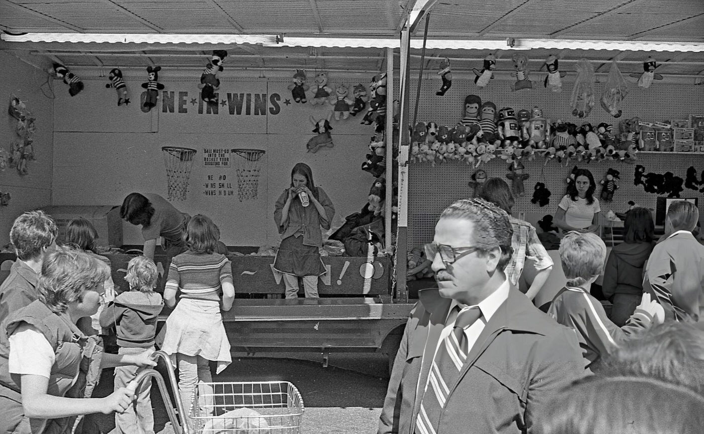 A Group Of People Gathered In Front Of One Of The Game Of Chance Booths At The Resurrection Ascension Church Carnival In Rego Park, Queens, 1979.