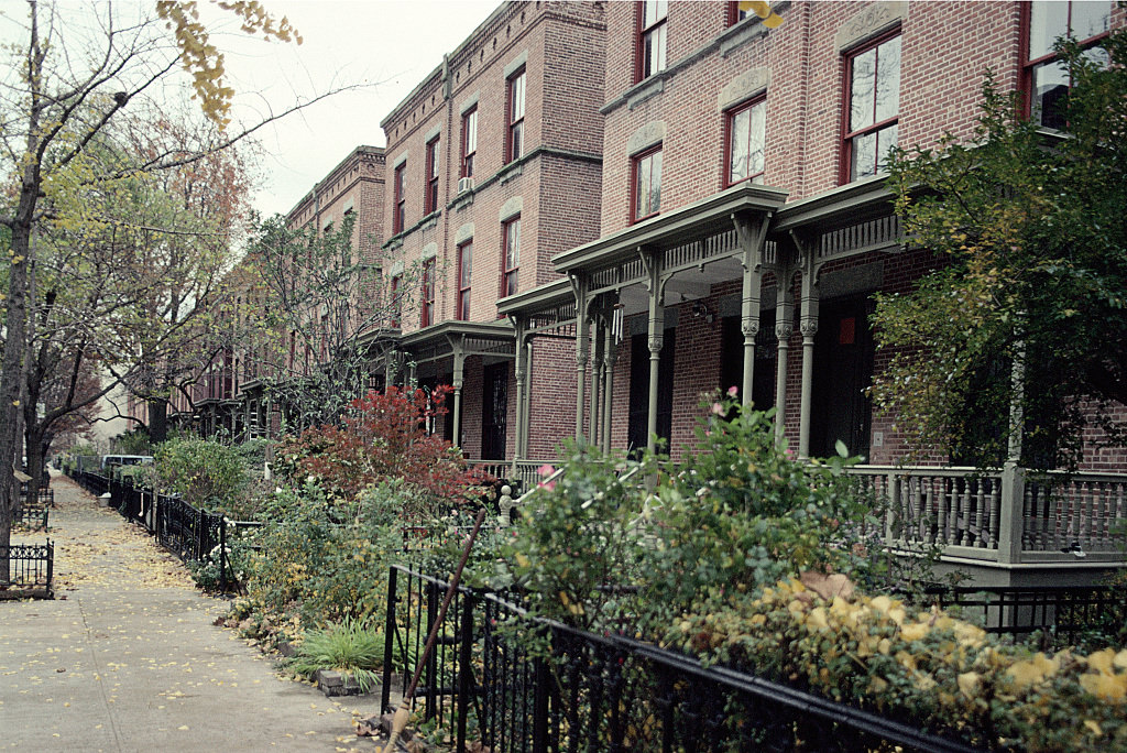 People Gathering Around A Box From Meals On Wheels, View North Along Lexington Ave. From E. 124Th St., Harlem, 2009.